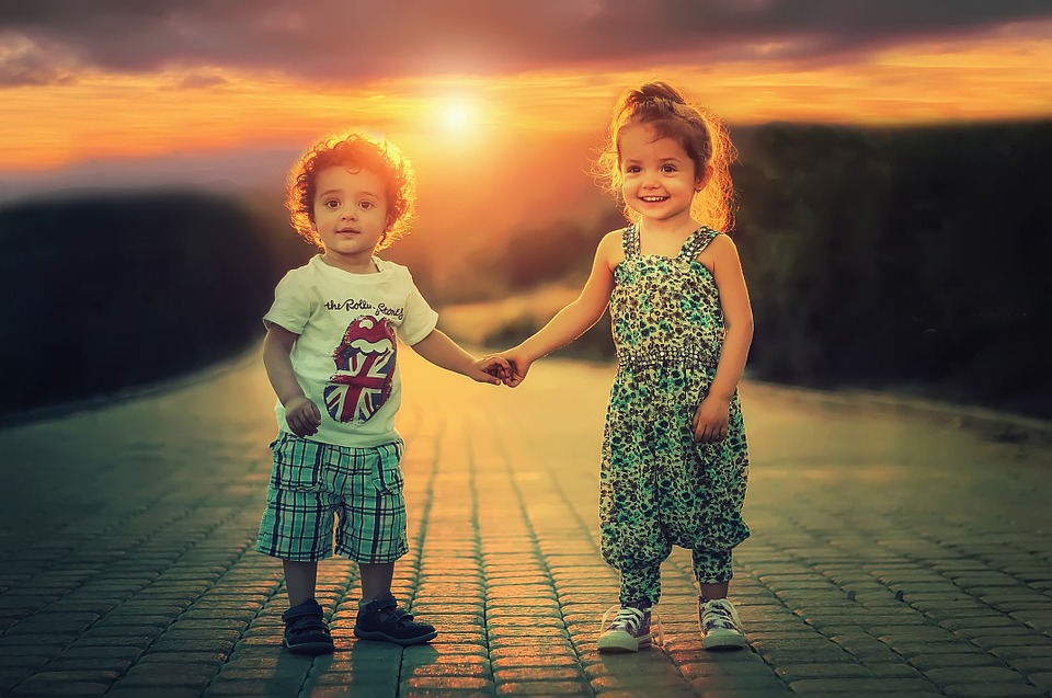 two toddlers holding hands